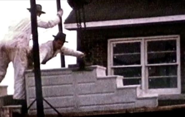 older colour photograph of workers installing concrete stairs