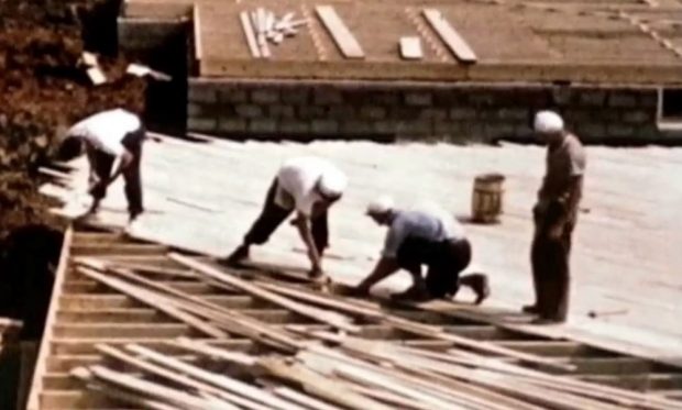 colour photograph of 2 men working on a construction site. Photo is taken at a bit of a distance