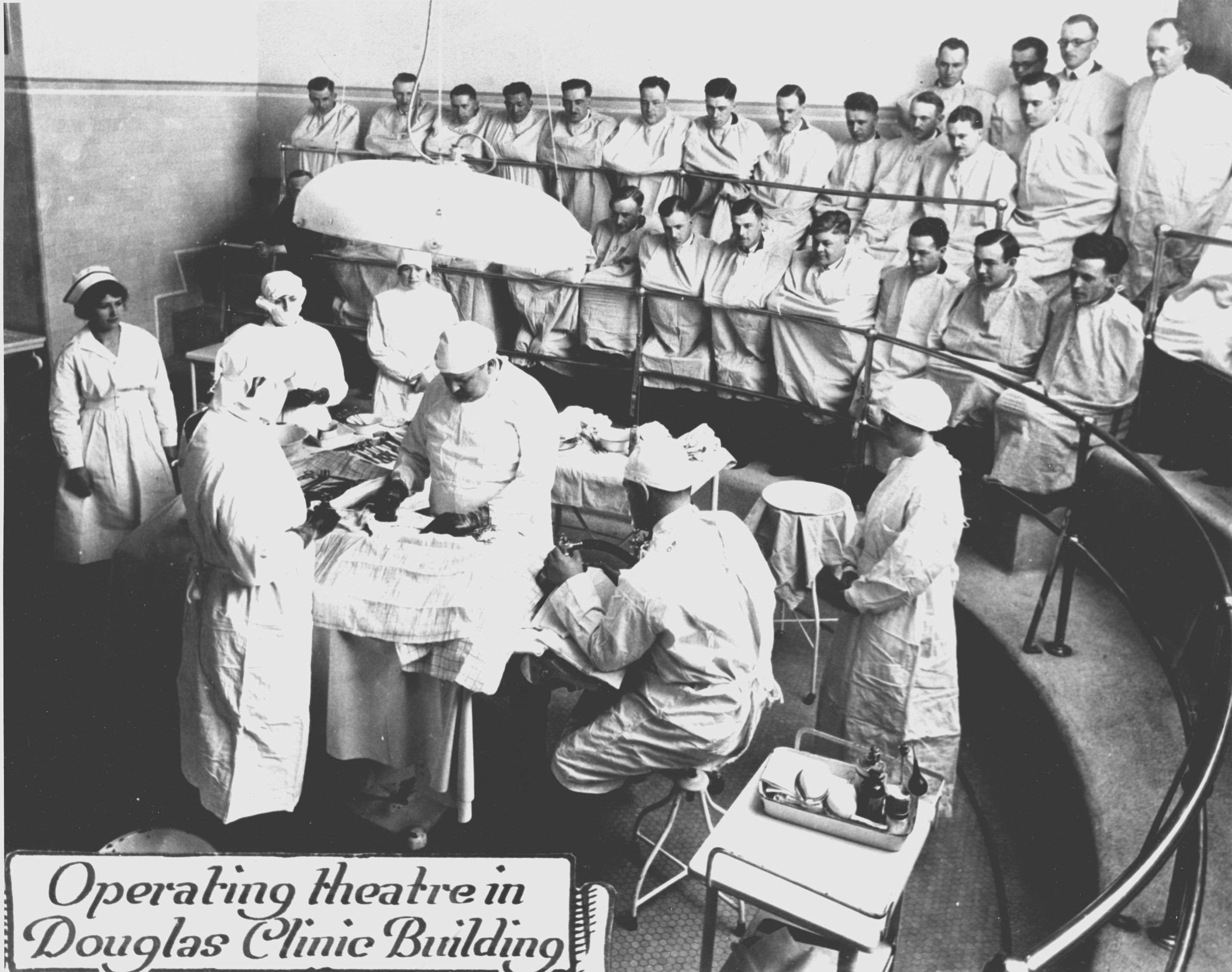 Photograph of doctors and nurses in attendance at the operating theatre, Douglas Clinic Building, 1927