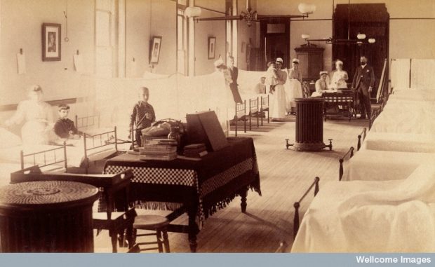 Period photograph of children patients, nurses and staff in a hospital ward in England, 1880