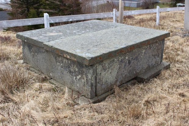 Colour photograph of the square, above-ground stone tomb of John Fergus and his daughter, Isabella.