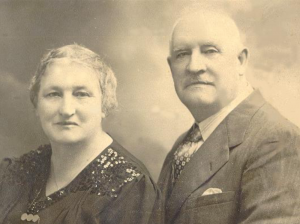 Black and white archival photograph showing a woman to the left and a man to the right.