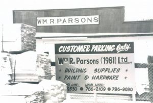 A photograph showing the exterior of a business premises, with two large painted signs showing the business name of William R. Parsons.