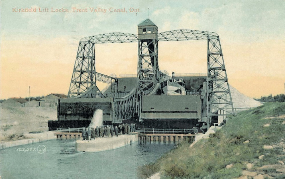 Colour image of lift lock with water in foreground and sunrise in background