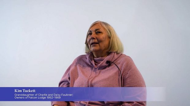 Woman in pink sweater sitting in chair with blue graphics in foreground