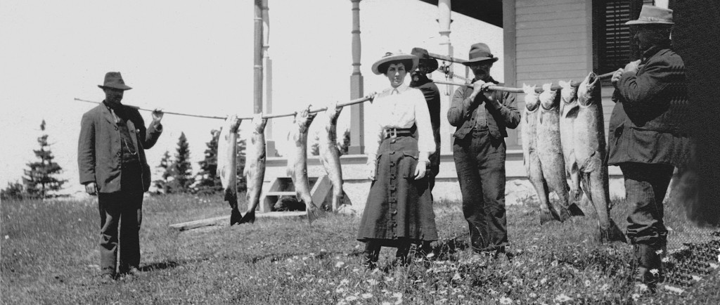 Silver print of Elsie Reford and her guides showing eight spectacular fish.