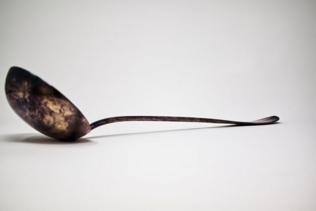 Photograph of a metal and silver ladle.