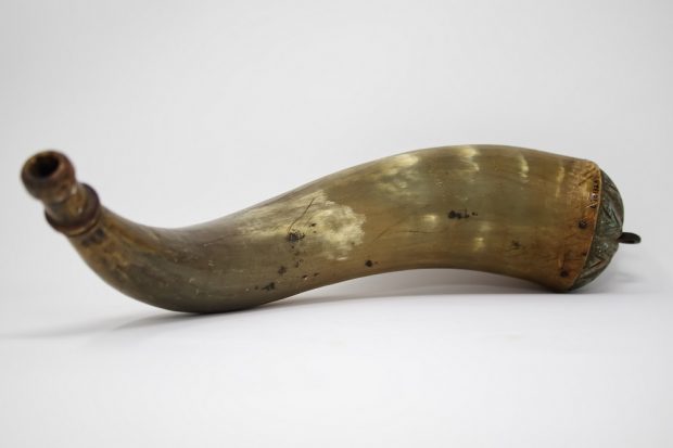 Photograph of a conical shape and curved ox horn used to store gun powder.