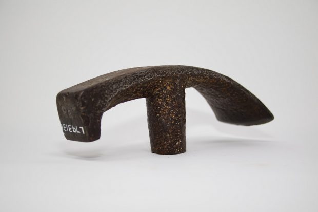 Photograph of the upper part of a cooper’s hammer made of cast iron and used by the first colonists for wood working.