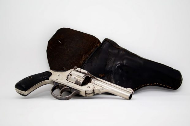 Service pistol with its holster which had belonged to J A Rousseau.
