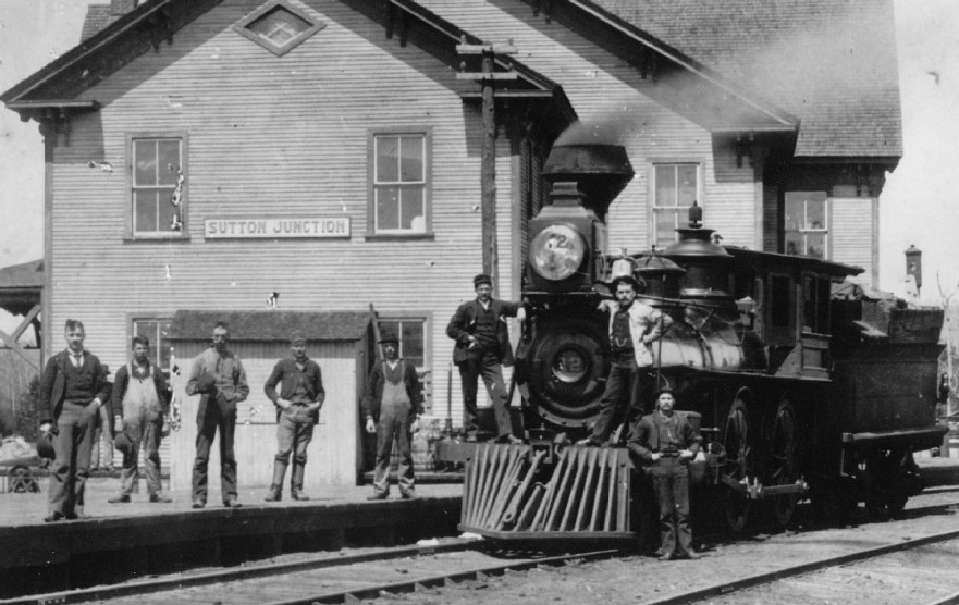 Railway workers pose with a locomotive that just arrived at Sutton Junction Station.