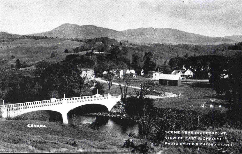 The elegant concrete structure that spans the Missisquoi River (on the left) arrives on the American side at East Richford (to the right).