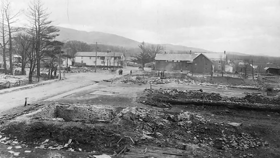 Looking south at the ruins along Main Street caused the fire on April 16, 1898. In the background the Dyer and Thompson & Greely stores are still standing.