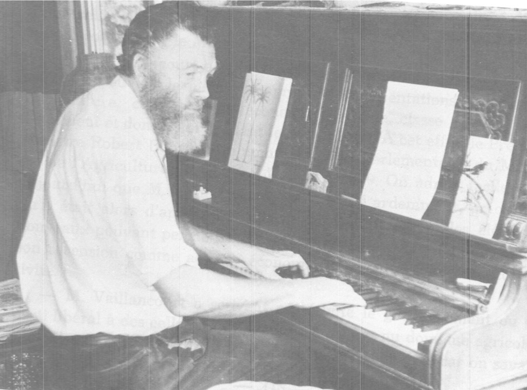 Black and white photograph of Dr. Cecil Meade seated at the piano. There is sheet music on the piano.