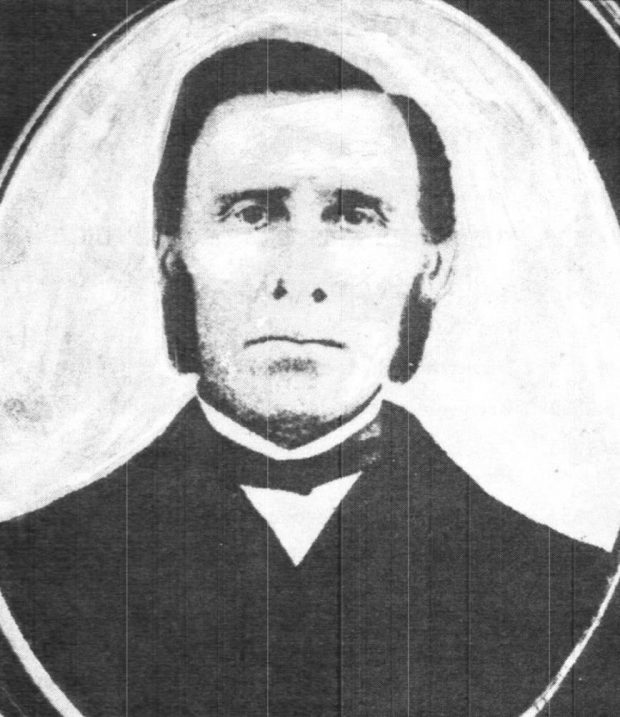 Black and white portrait image of Richard Baldwin, Jr. wearing a black suit, white shirt, and a black bow tie.