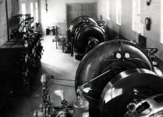 Black and white photograph showing machines and equipment in one section of the Coaticook Power Station.