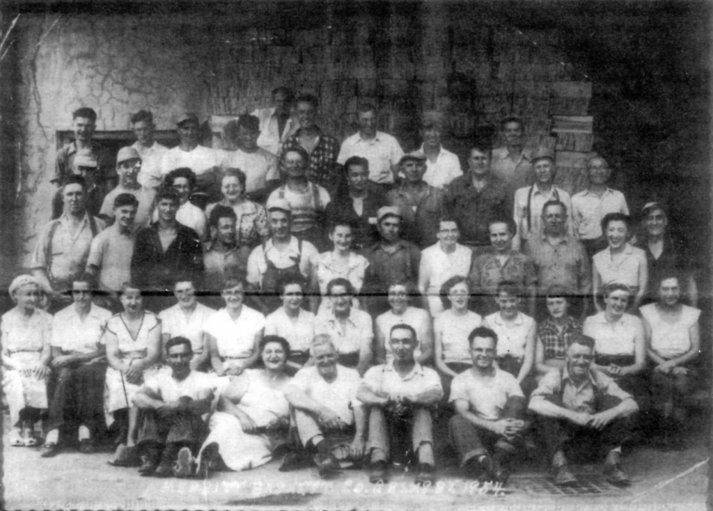 Large group of factory workers posing for a group picture
