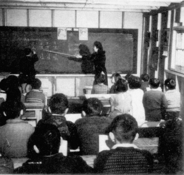 Woman in a schoolroom teaching children