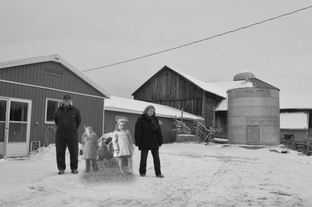 B&W photograph of two children and turkeys, superimposed on a contemporary photo of the farm.