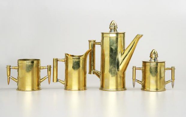 A tea set made from polished brass casings and bullets.