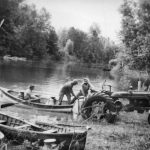 Loading Milk Cannisters onto a Row Boat During the 1948 Flood