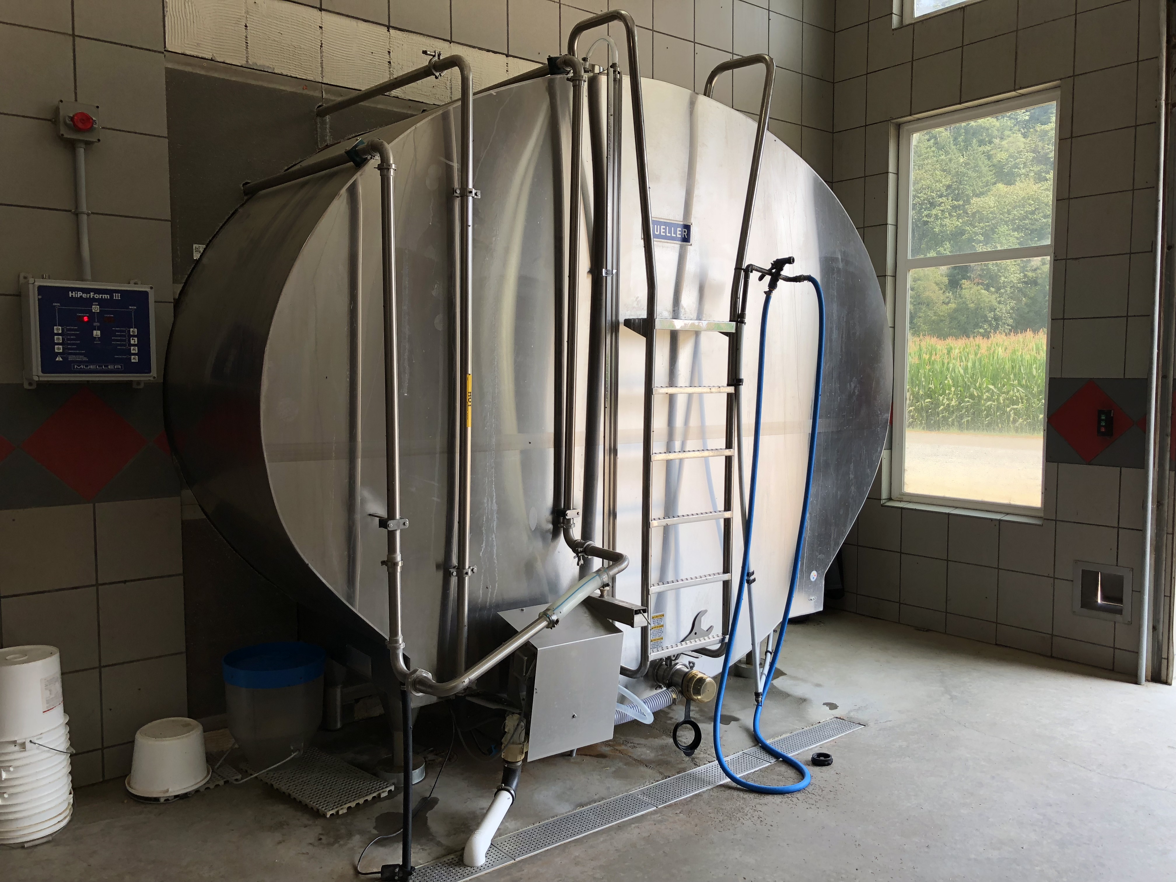 Colour photograph of a stainless steel milk storage tank.