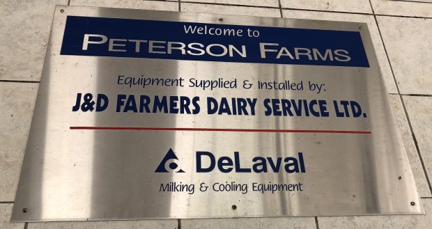 Colour photograph of stainless steel sign Welcome to Peterson Farms.
