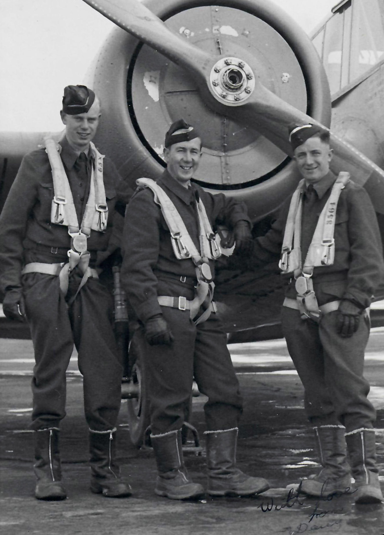 three men in uniform in front of airplane