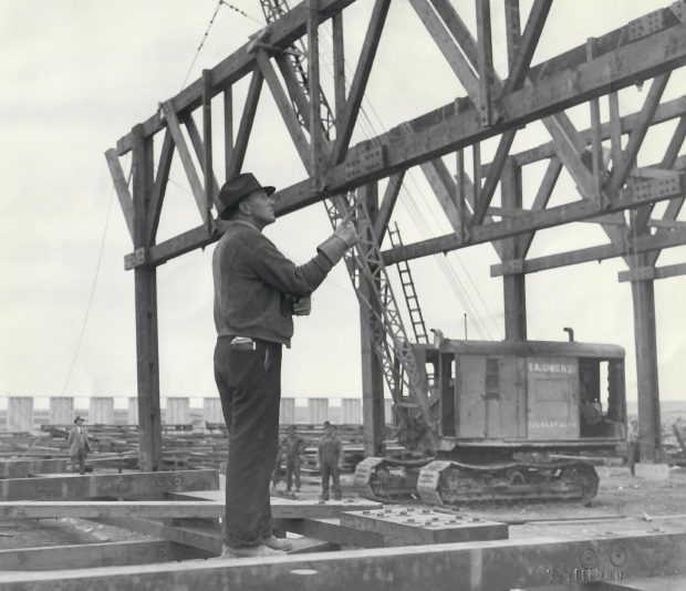 Large man with construction and crane