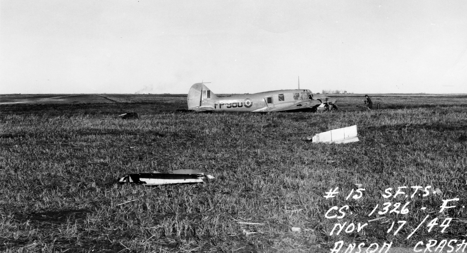 plane crash in field with airwoman taking photos