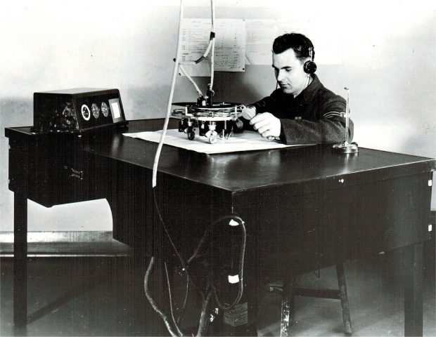 Man in headphones sitting at a desk