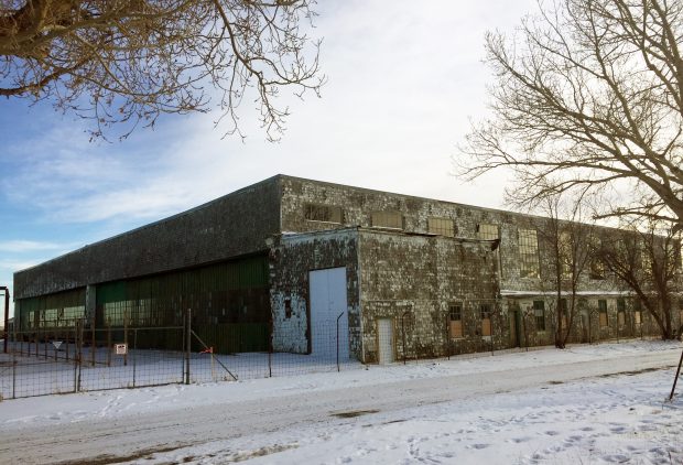 old airplane hangar with snow on ground