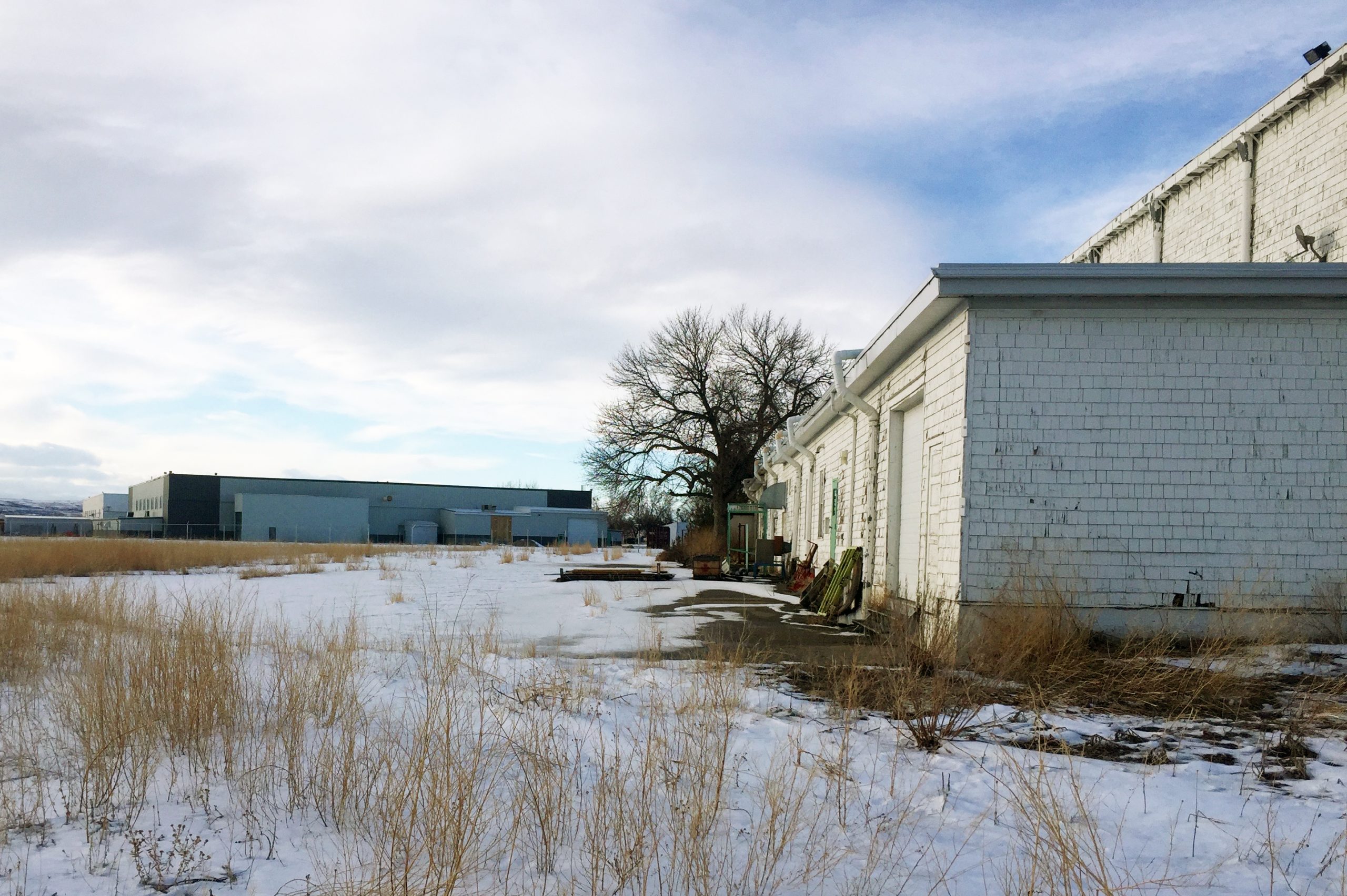 three airplane hangars with snow on ground