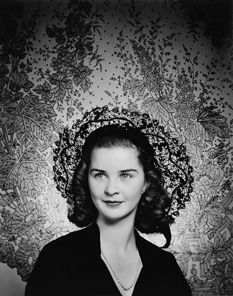 Black-and-white portrait of a woman wearing a hat.