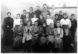 Group of schoolchildren posing with thier teacher