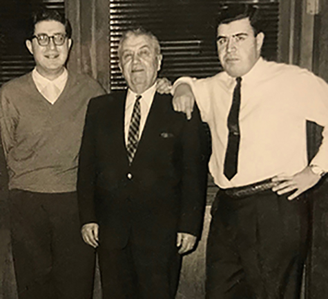 In this picture, William Cook Sr is surrounded by his sons. William Jr is on the left and Gordon on the right.