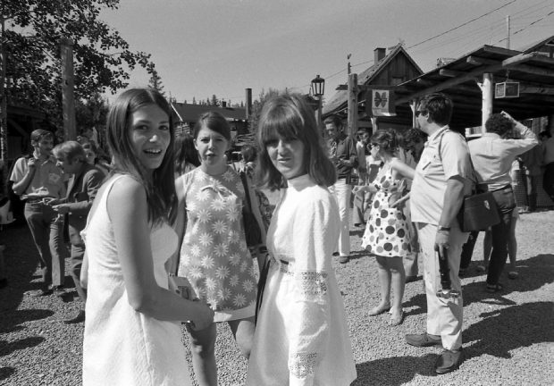 Black and white photo of a group of young women in summer dresses among the spectators outside La Butte.