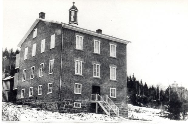 Three-storey brick building.