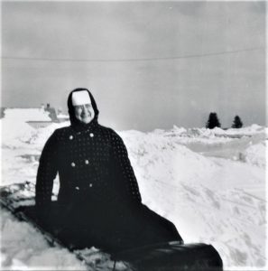 Photo of a nun on a luge in the snow.