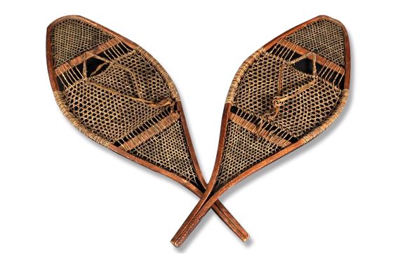 A pair of handcrafted snowshoes with a wooden frame and webbing made of babiche (strips of leather).