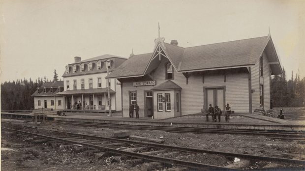 Sepia-toned photo of the Lac-Édouard train station; on the left stands lac Édouard’s private club, Laurentide House.
