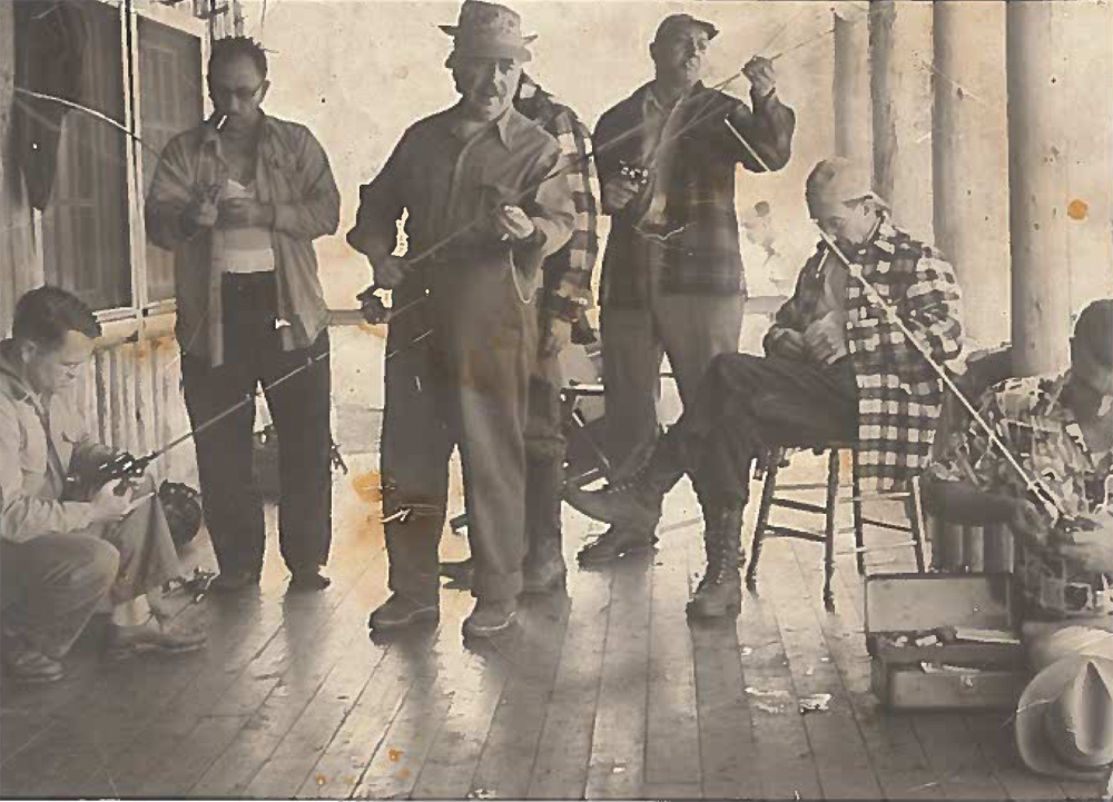 Photo sepia, a group of fishermen on a gallery organizing for a fishing trip.