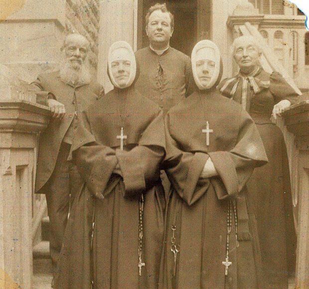 Sepia picture of nuns Marie-Philomène and Marie-Louise. Behind them are Alfred-Narcisse LePailleur, Bishop Georges-Marie (in the priest's habit) and Philomène Dalton.