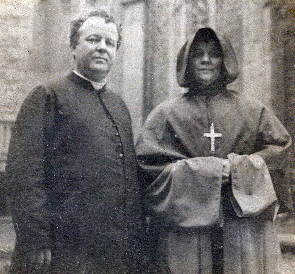 Black and white picture of Bishop Georges-Marie in his soutane and Sister Agnes in her religious habit posing side by side.