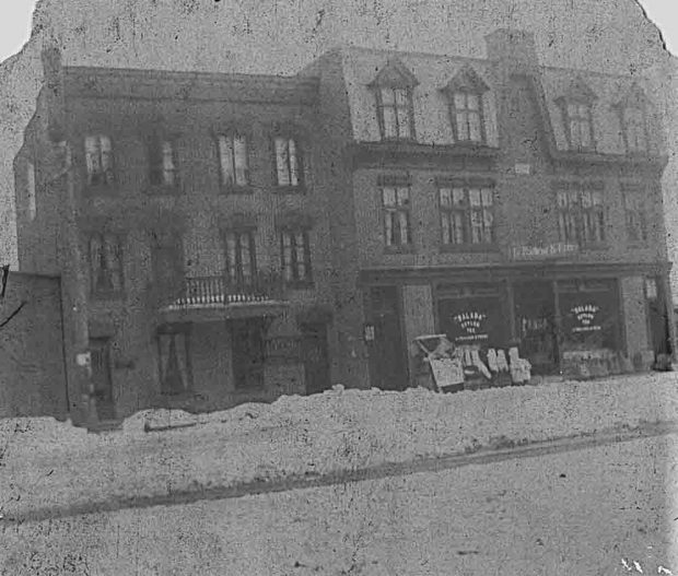 Black and white picture of the LePailleur et Frères business. There is snow on the road.