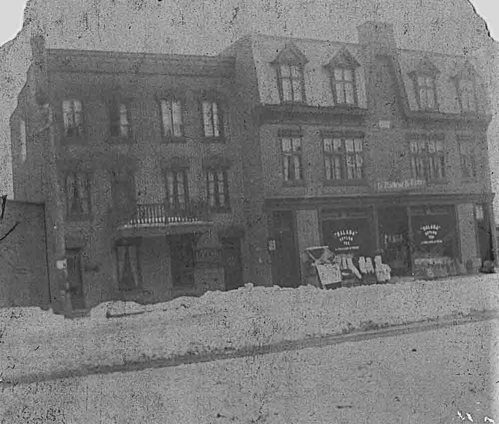 Black and white picture of the LePailleur et Frères business. There is snow on the road.