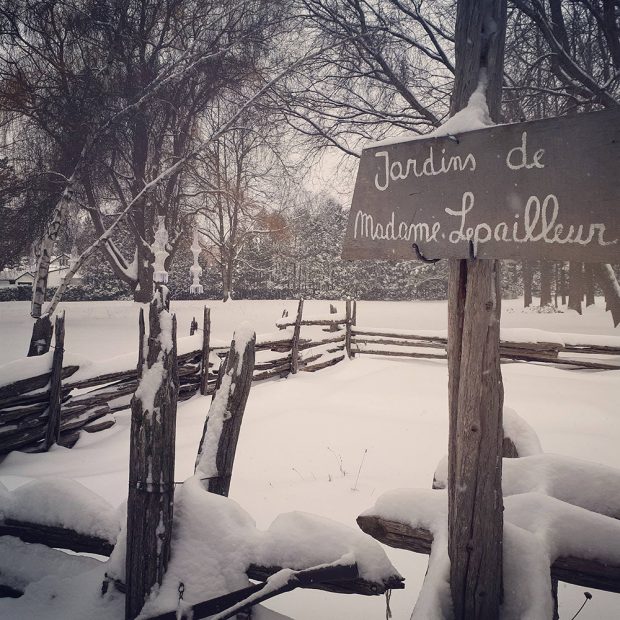 Photograph of the vegetable garden located at the back of the Maison LePailleur. It is covered with snow.