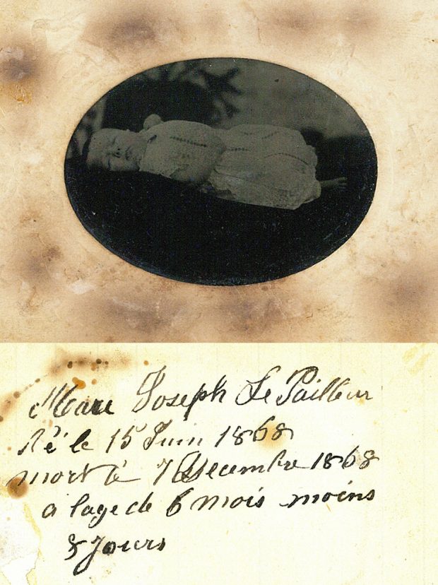 Montage of the front and back of a tintype. On the front, there is an oval picture of a baby lying on his back with his eyes closed. On the back, there are handwritings in black ink.