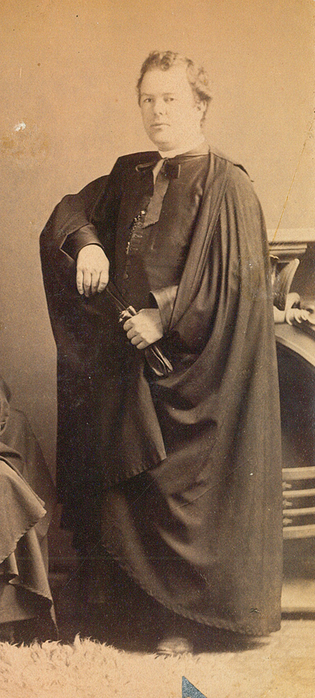Sepia picture of Georges-Marie LePailleur dressed as a clergyman. He poses for the photographer.