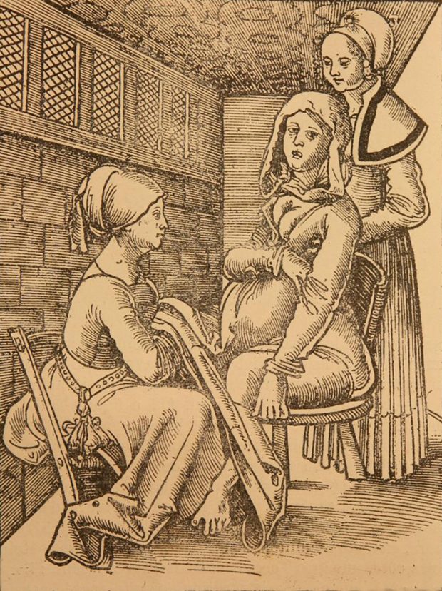 Illustration from a book. A woman is sitting on a chair, with a midwife at her feet and another one behind her helping her.